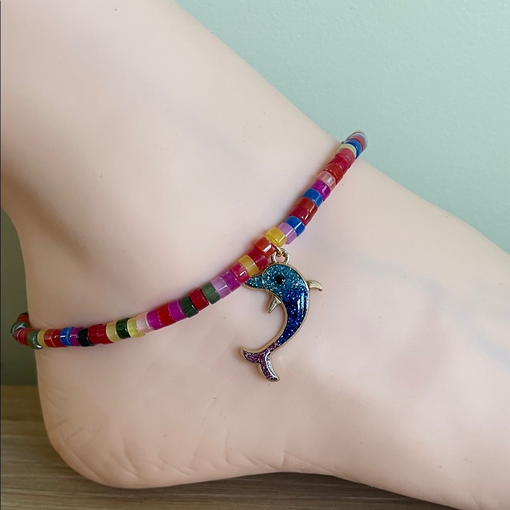 HAND CRAFTED RAINBOW GLASS BEADED ANKLET WITH A GLITTER DOLPHIN CHARM.